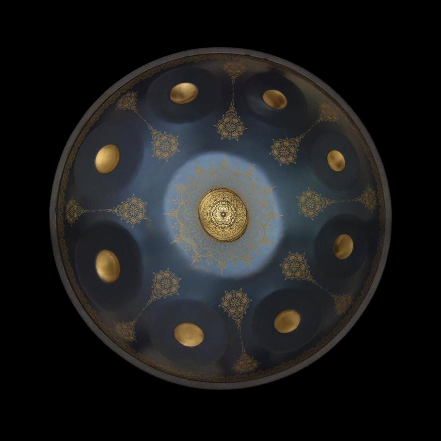 a blue and gold plate with gold dots on it