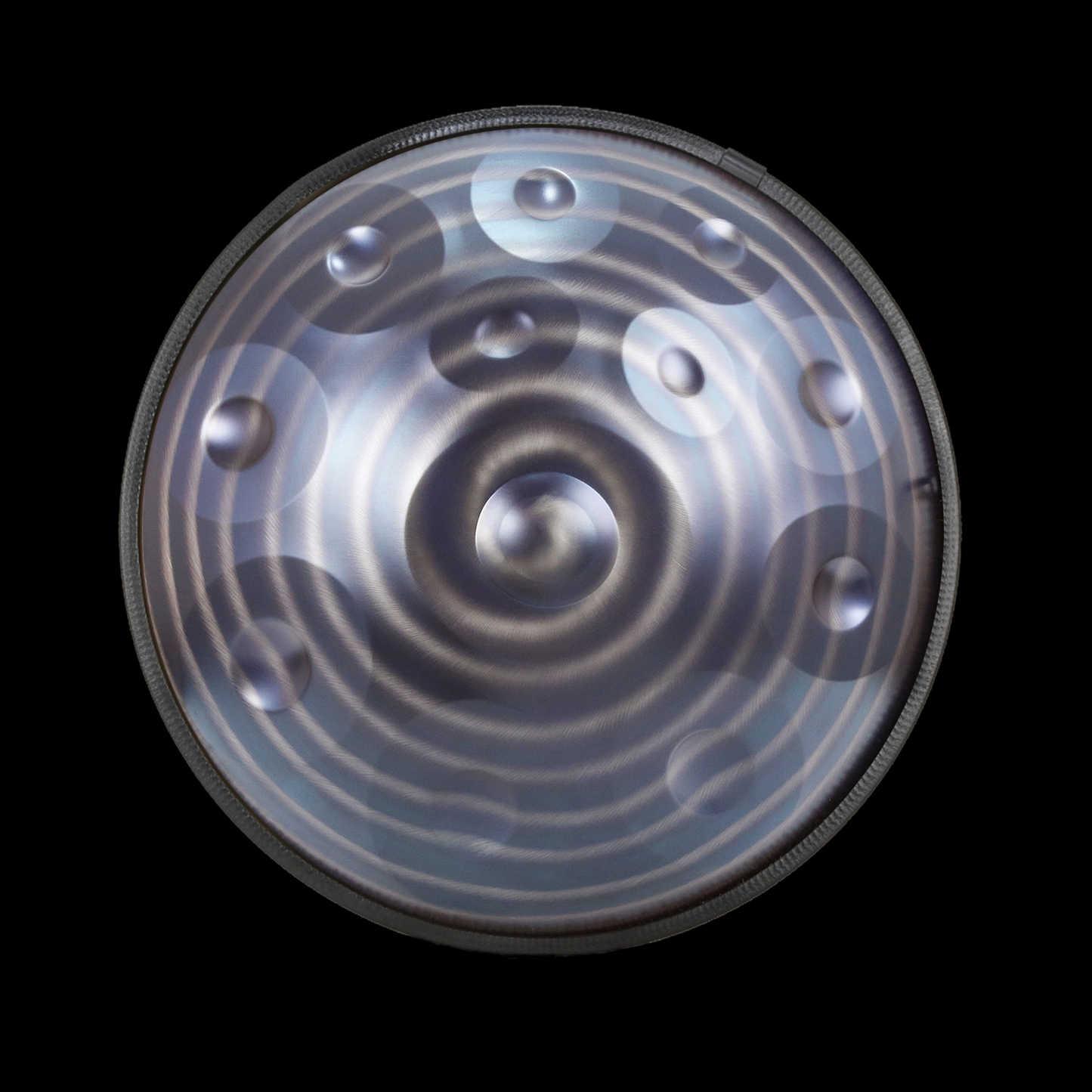 a circular metal object with a black background