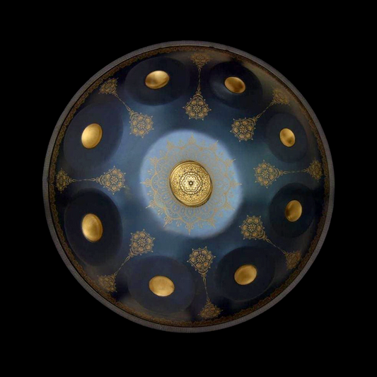 a blue and gold plate with gold dots on it