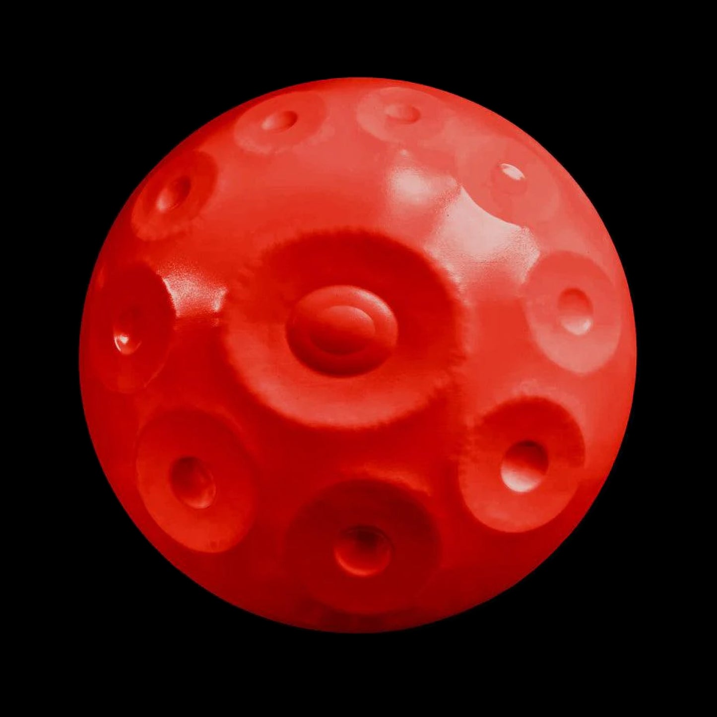 a close up of a red object on a black background